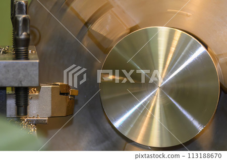 The lathe machine rough cut the brass material parts by lathe tools. The lathe machine rough cut the brass material parts by lathe tools. 113188670