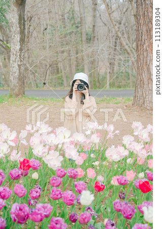 A woman takes pictures of a beautiful tulip field in a park in Saitama A woman takes pictures of a beautiful tulip field in a park in Saitama 113189304