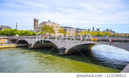 Arched Pont au Change spans the Seine River against a backdrop of Parisian architecture on a clear day. Paris, France 113189412