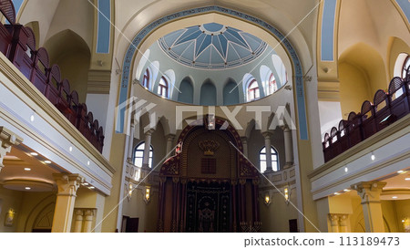 The synagogue building is inside. A two-tiered hall with domes and windows. 113189473