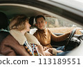 Adult couple on a autumn road trip, man and woman sitting in the car and looking on each other 113189551