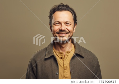A man with a beard and a smile is wearing a brown jacket and a yellow shirt A man with a beard and a smile is wearing a brown jacket and a yellow shirt 113190631