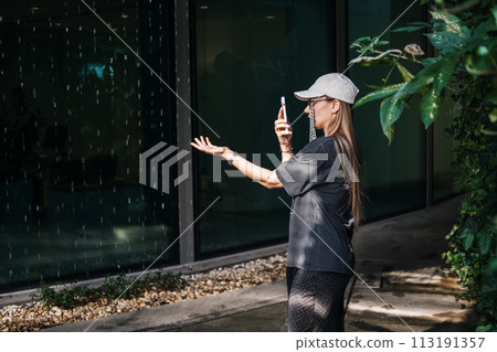 Contemplative Woman by Green Wall in City 113191357