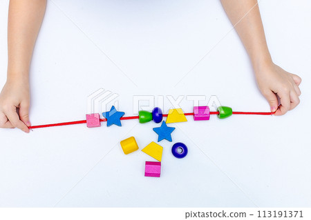 Colourful child's bead bracelet, isolated on a white background 113191371