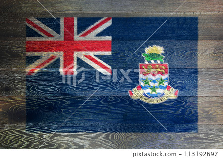 Cayman Islands flag on rustic old wood surface background Cayman Islands flag on rustic old wood surface background 113192697