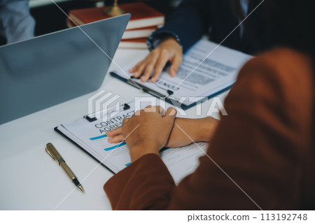Businessman and lawyer discuss the contract document. Treaty of the law. Sign a contract business. Businessman and lawyer discuss the contract document. Treaty of the law. Sign a contract business. 113192748