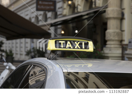 Checker taxi lighted rooftop car on a blurred background 113192887