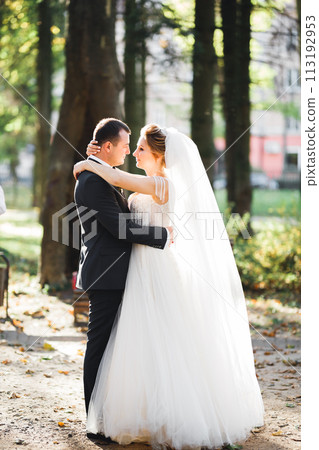 Gorgeous happy couple standing close to each other and looking in eyes 113192953