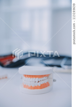 Denture and dental tools,dental mirror on white background 113193639