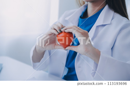 Doctor explaining heart to elderly patient. Doctor explaining the heart model. Doctors pen point to a model of the heart Doctor explaining heart to elderly patient. Doctor explaining the heart model. Doctors pen point to a model of the heart 113193696