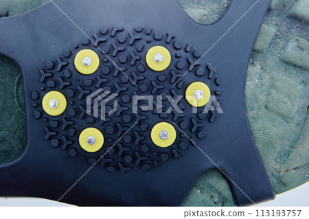 Anti slip covers with spikes on shoes for ice grips. 113193757