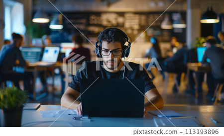 Man Listening to Music With Headphones at Laptop Man Listening to Music With Headphones at Laptop 113193896