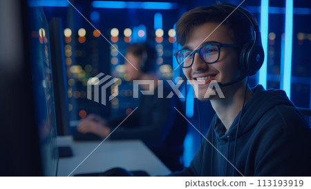 Man Wearing Headphones Working on Computer Man Wearing Headphones Working on Computer 113193919