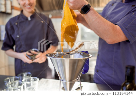 Professional cooks working in restaurant Professional cooks working in restaurant 113194144