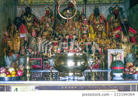 Figurines of deities in chinese Jui Tui temple in Phuket, Thailand. Shrine worship shelf with many gods, selective focus 113194364