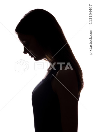 Young woman look down with flowing hair - vertical silhouette 113194467