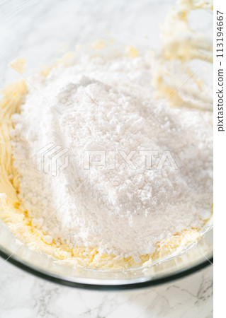 In a large mixing bowl, the ingredients are expertly mixed to create a delectable cream cheese buttercream for the Carrot Bundt Cake. 113194667