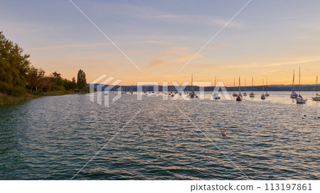 Bodensee Lake Sunset Panorama. Evening Sunlight Over Tranquil Waters. Sunset Vista at Lake Bodensee in Germany. 113197861