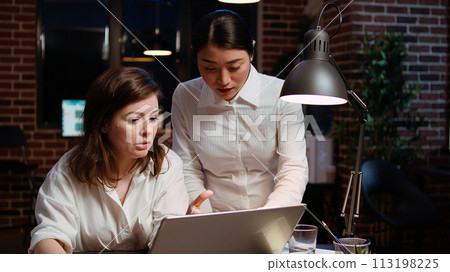 Worker brainstorming with colleague to write email at computer desk, finalizing deal with business partners. Coworkers using laptop to make agreement over internet with associates, zoom in shot 113198225