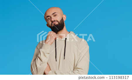 Middle eastern person thinking about a thing on camera, acting pensive and puzzled while trying to make a decision. Arab guy acting thoughtful and unsure about a question. Camera 2. Middle eastern person thinking about a thing on camera, acting pensive and puzzled while trying to make a decision. Arab guy acting thoughtful and unsure about a question. Camera 2. 113198317