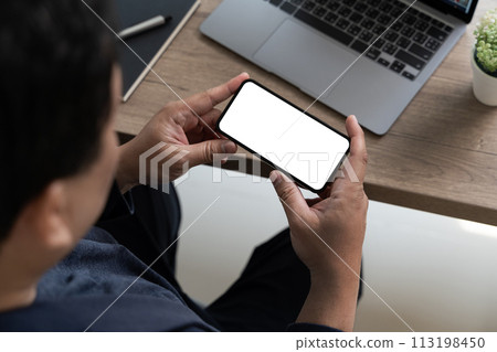 Top view Mockup image hand using a smartphone man Holding Cell Phone With Blank Screen 113198450