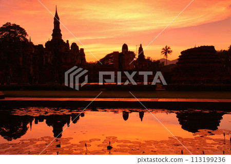 Silhouette of Wat Mahathat ruins at sunset in Sukhothai Historical Park, a world cultural heritage site in Sukhothai, the ancient capital of northern Thailand 113199236