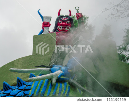A red demon statue stands at Kamado Jigoku 2-chome, one of the Beppu Hell Tours and a sacred place for the anime Demon Slayer: Kimetsu no Yaiba. A red demon statue stands at Kamado Jigoku 2-chome, one of the Beppu Hell Tours and a sacred place for the anime Demon Slayer: Kimetsu no Yaiba. 113199539