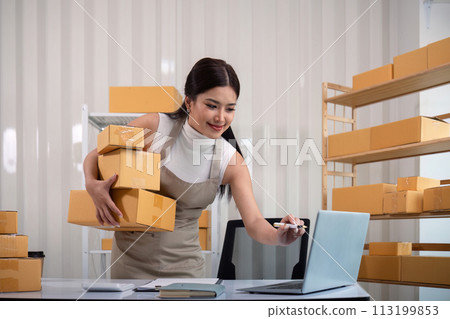 Woman asian in an online store check the customer address and package information on the laptop. Online shopping concept 113199853