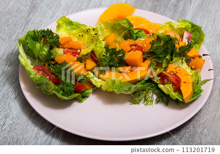 Salad of baked pumpkin, cherry tomatoes, sesame, sauce and greens 113201719