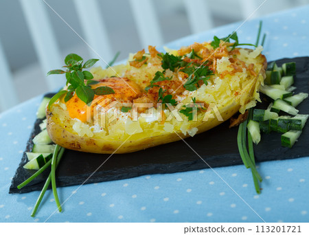 Baked potato with herbs, egg and cucumbers Baked potato with herbs, egg and cucumbers 113201721