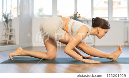 Young woman practicing hatha yoga in studio Young woman practicing hatha yoga in studio 113201929