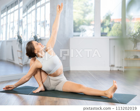 Fitness trainer girl performs preparatory exercises, warm-up 113202019