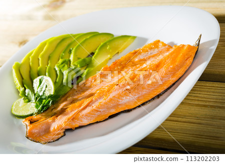 Photography of plate with fried trout fillet with avocado Photography of plate with fried trout fillet with avocado 113202203