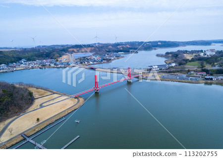 Drone | Aerial shot of the red-shining Iris Bridge over Lake Kitagata | Awara City, Fukui Prefecture 113202755