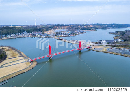 Drone | Aerial shot of the red-shining Iris Bridge over Lake Kitagata | Awara City, Fukui Prefecture 113202759