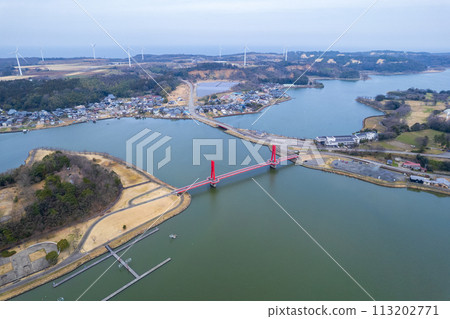 Drone | Aerial shot of the red-shining Iris Bridge over Lake Kitagata | Awara City, Fukui Prefecture 113202771