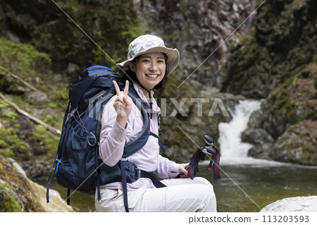 Woman enjoying hiking Woman enjoying hiking 113203593