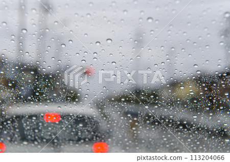 Water drops on the windshield and the passenger car in front Water drops on the windshield and the passenger car in front 113204066