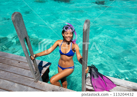 Travel Vacation Snorkeling. Snorkel swim woman in tropical coral reef resort. This image is completely unretouched and unedited and model is with no makeup. Authentic real people. Original Raw Image Travel Vacation Snorkeling. Snorkel swim woman in tropical coral reef resort. This image is completely unretouched and unedited and model is with no makeup. Authentic real people. Original Raw Image 113204432