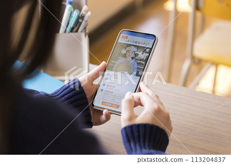 Female high school student looking at job information on her smartphone during break 113204837