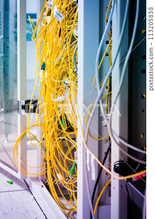 data center with bundle of fiber optics cables connected to data switch 113205838