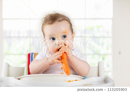 Baby eating vegetables. Solid food for infant. 113205903