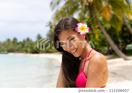Skincare woman on luxury travel beach vacation. Portrait of beautiful woman in bikini smiling, French Polynesia. Image is completely unretouched and model is without makeup. Real people. Raw Image 113206007