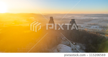 Trosky medieval castle ruins at cold morning sunrise time. Bohemian Paradise, Czech: Cesky raj, Czechia. Aerial view from above. 113206569