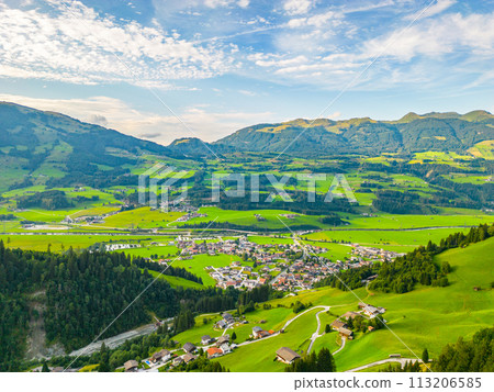 A scenic view of Hollersbach im Pinzgau with lush green fields and rolling hills under a clear sky. Hohe Tauern, Austria 113206585