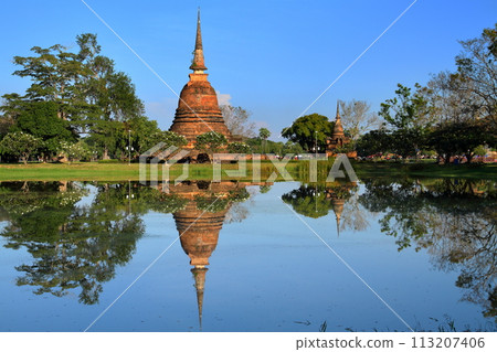 Wat Sashi Temple pagoda and pond water mirror in Sukhothai Historical Park, a world cultural heritage site in Sukhothai, the ancient capital of northern Thailand 113207406