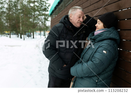 Mature husband and wife walking down the street 113208232