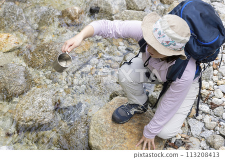 Woman enjoying hiking Woman enjoying hiking 113208413