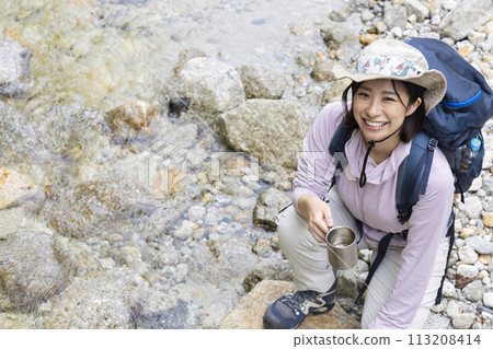 Woman enjoying hiking Woman enjoying hiking 113208414