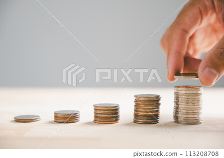 Graph featuring an ascending arrow symbolizes the surging real estate market. Alongside, house model stack of coins symbolize inflation, economic growth, insurance service expenses. Value is on rise. Graph featuring an ascending arrow symbolizes the surging real estate market. Alongside, house model stack of coins symbolize inflation, economic growth, insurance service expenses. Value is on rise. 113208708
